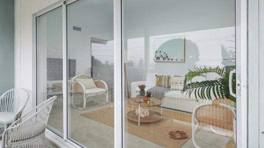 White framed sliding glass doors looking into living area