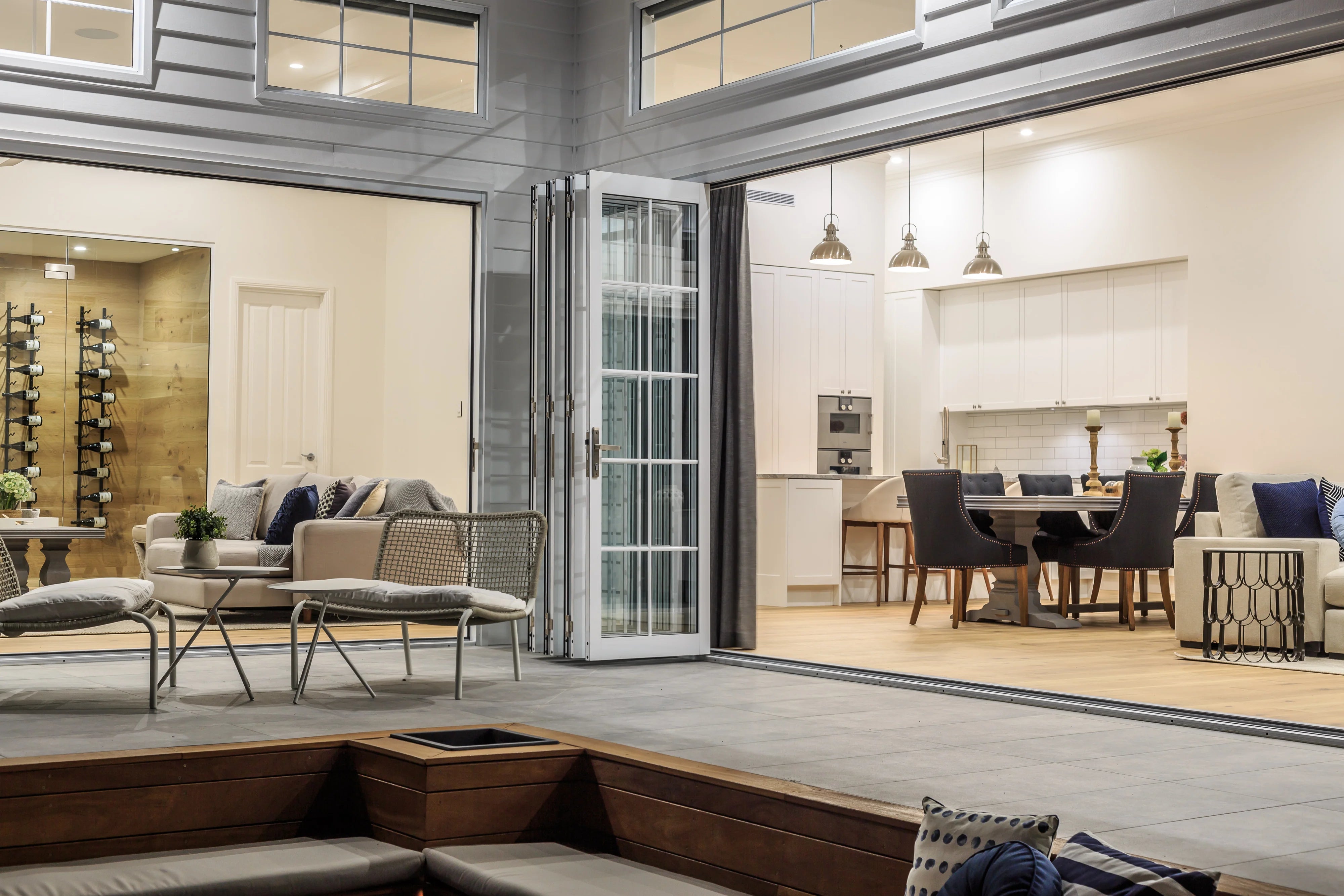 Modern living room with bi-fold door, showing the living room and dining area.