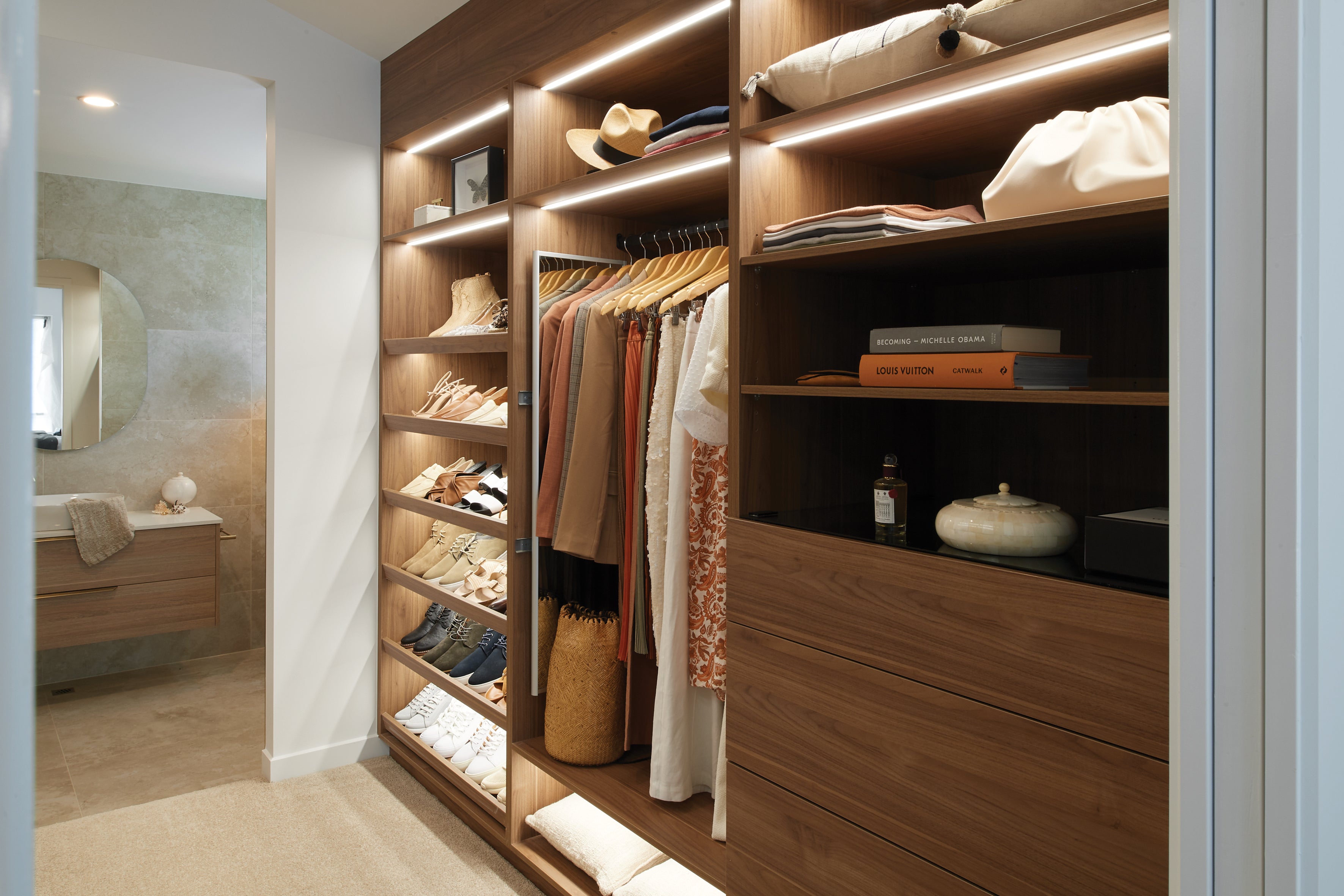 Modern walk-in closet with wooden shelves and clothing