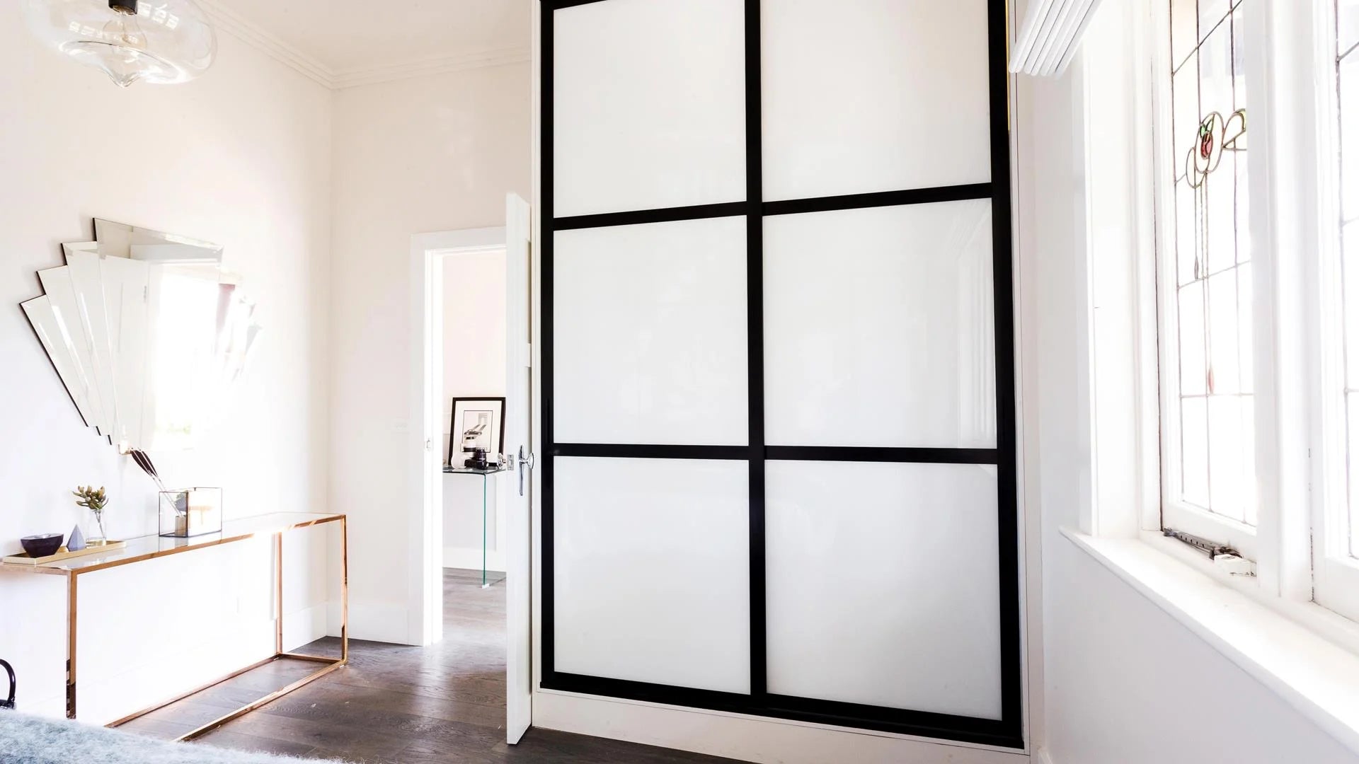 Modern interior design with a Hiro sliding glass door in a well-lit room.