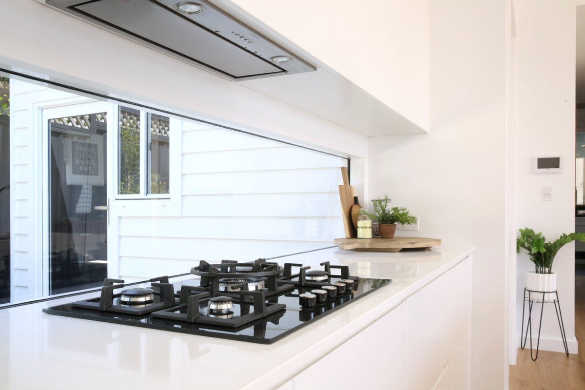 Modern kitchen with a black stovetop and fixed window