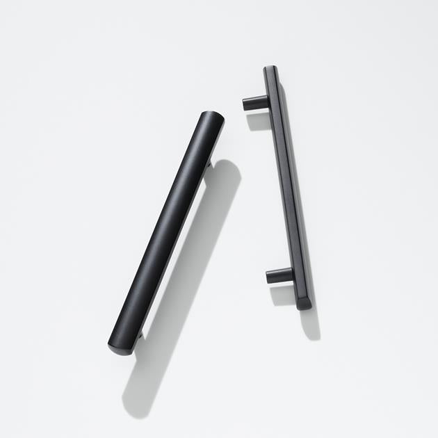 Black cabinet handles on a white background