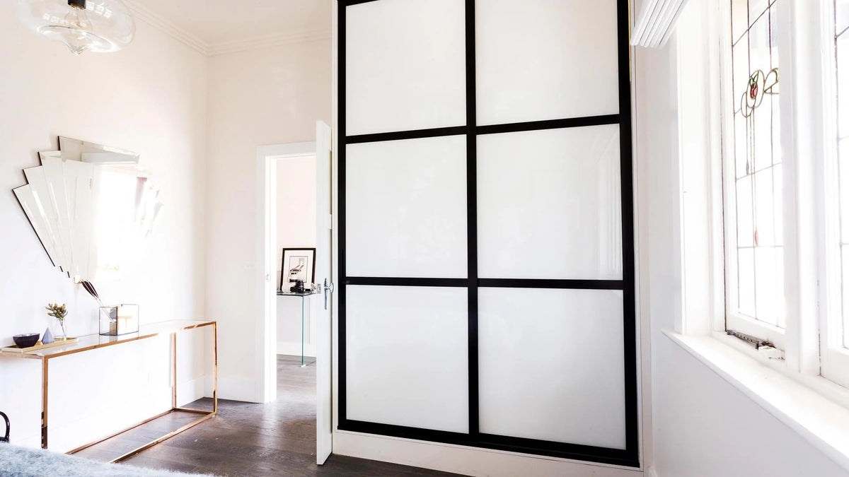 Modern interior design with a Hiro sliding glass door in a well-lit room.