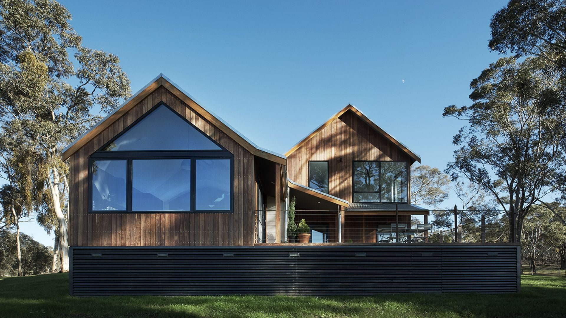 Modern wooden house with large windows in a natural setting