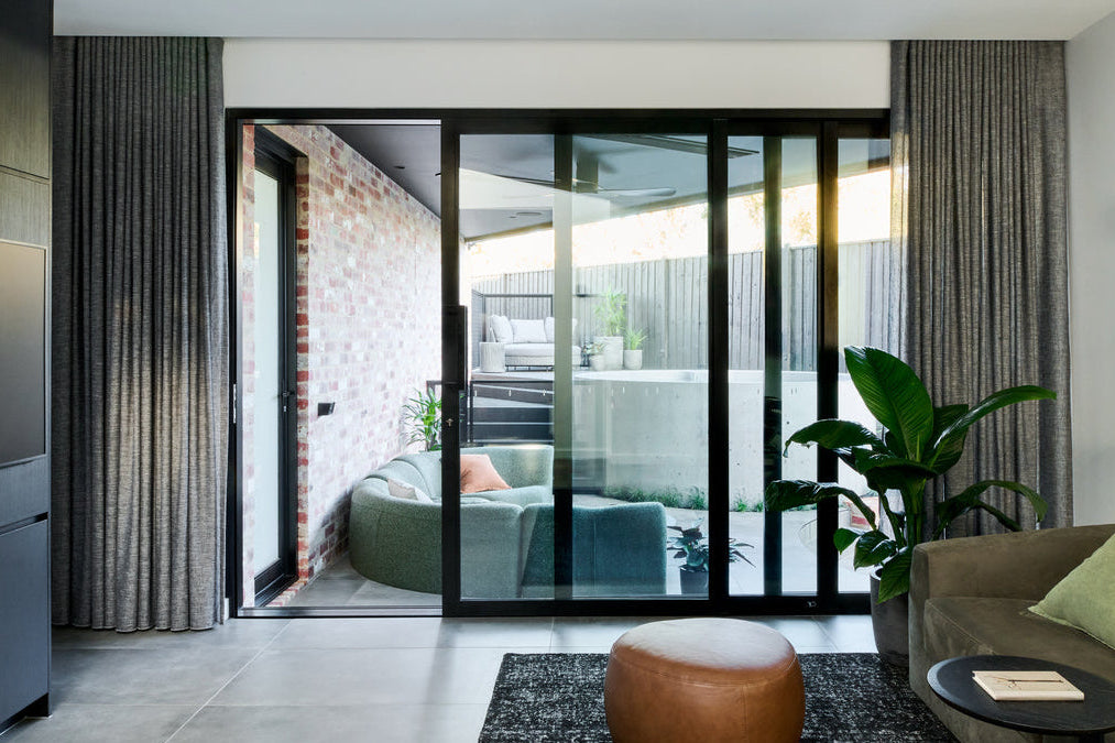 Modern living room with a glass door leading to an outdoor area.