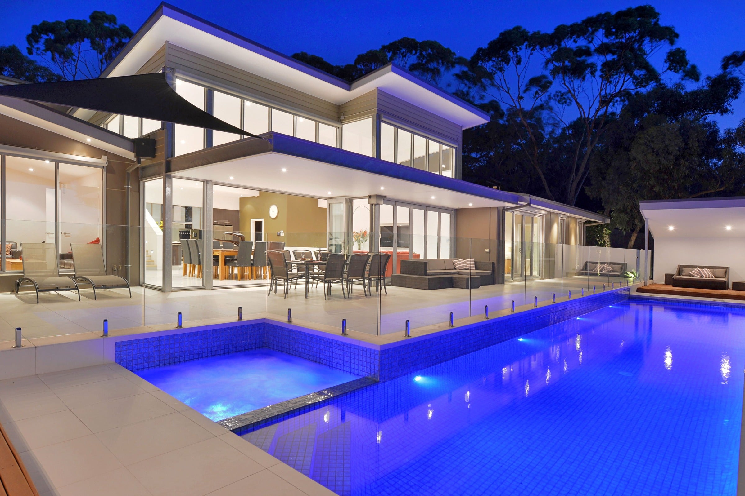 Modern house with a pool at night