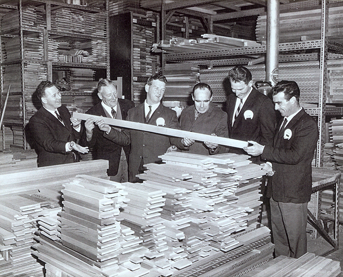 Group of men inspecting timber door