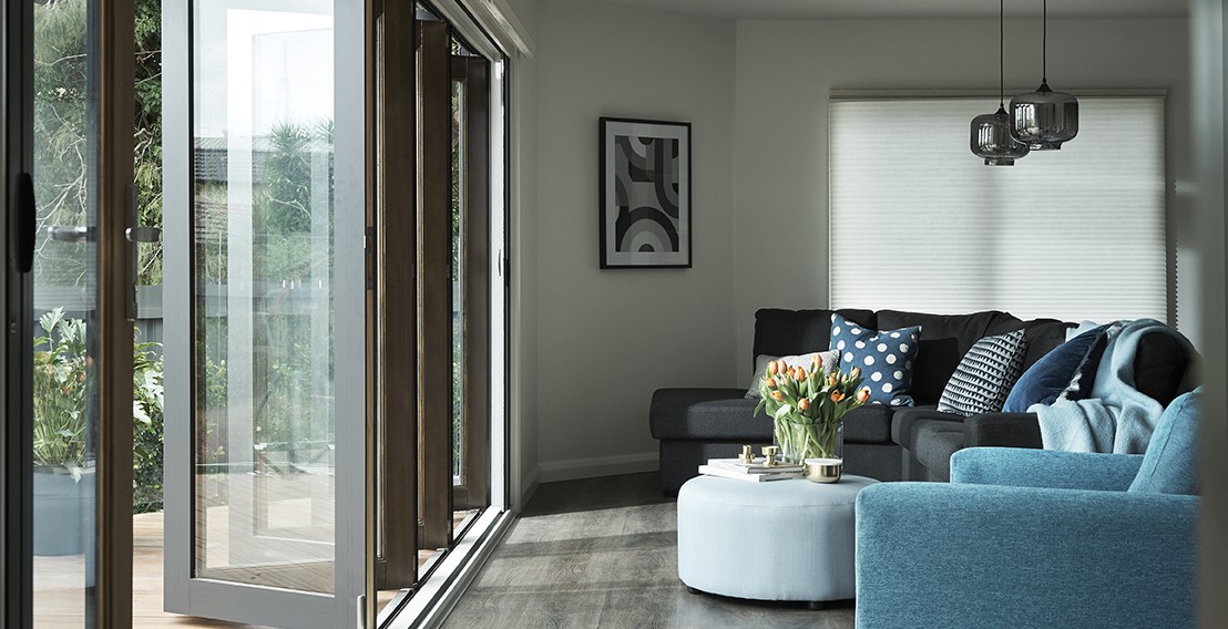 Living area with Siteline bifold doors in woodland grey powdercoat colour